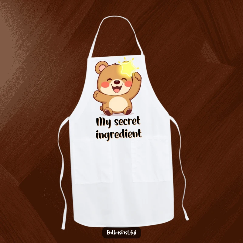 Funny bear apron showing a joyful bear with a wide grin, holding a glowing, imaginary object, ready for the kitchen.
