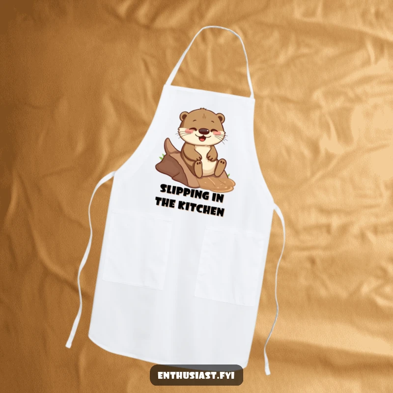 Funny apron showing a playful otter joyfully sliding down a small, muddy incline, adding humor to kitchen tasks.