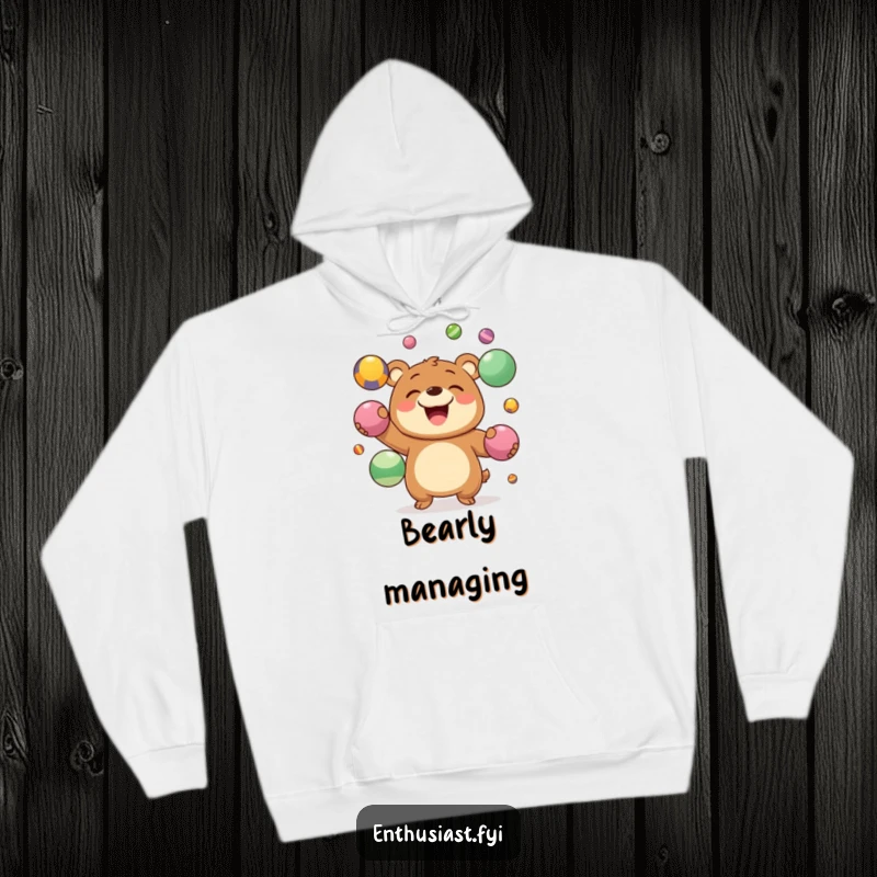 Funny Hoodie featuring a joyous bear character with a big grin, juggling colorful balls, a humorous and cozy item.