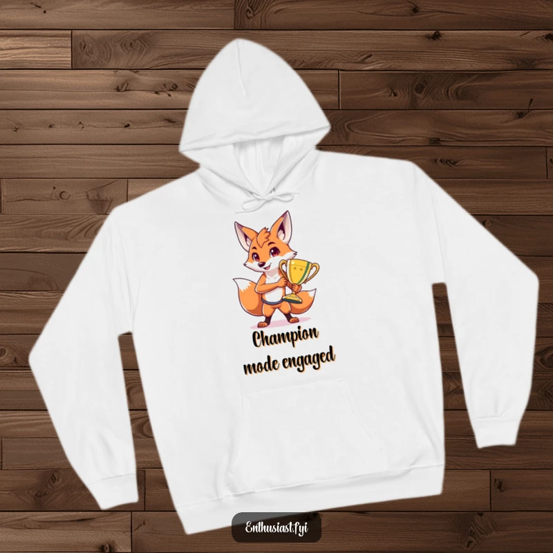Funny hoodie with a proud fox character striking a pose beside a massive, shiny trophy, exuding an air of triumphant celebration.