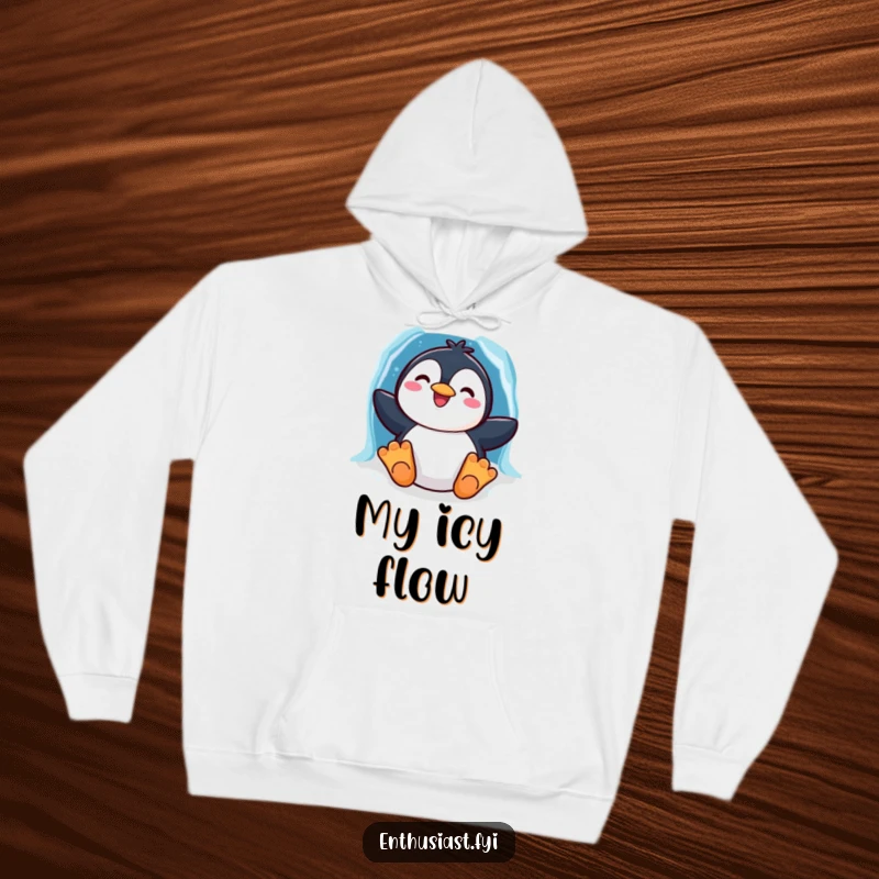 Funny hoodie with a cheerful penguin character sliding down a vibrant rainbow ice chute, offering warmth and winter fun.