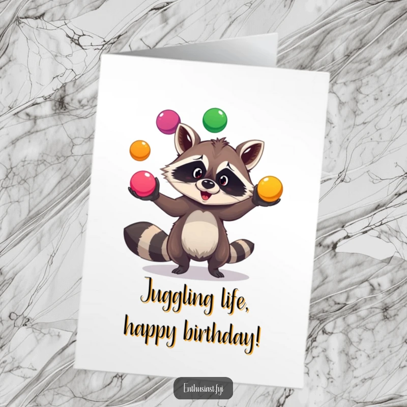 Funny Free Printable Birthday Card showing a goofy raccoon skillfully juggling three bright, colorful balls with a mischievous grin.