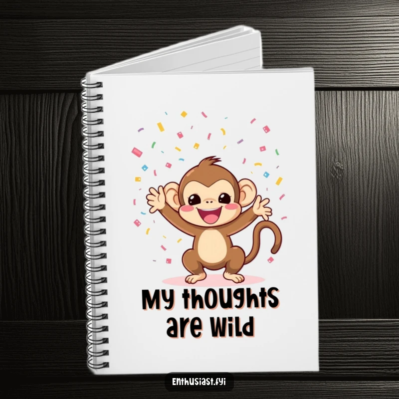 Funny monkey notebook with a cheerful character tossing confetti on the cover, perfect for note-taking.