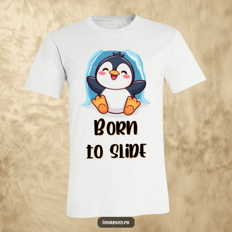 Funny t-shirt with a cheerful penguin character sliding down a rainbow-colored ice chute, embodying pure winter joy.