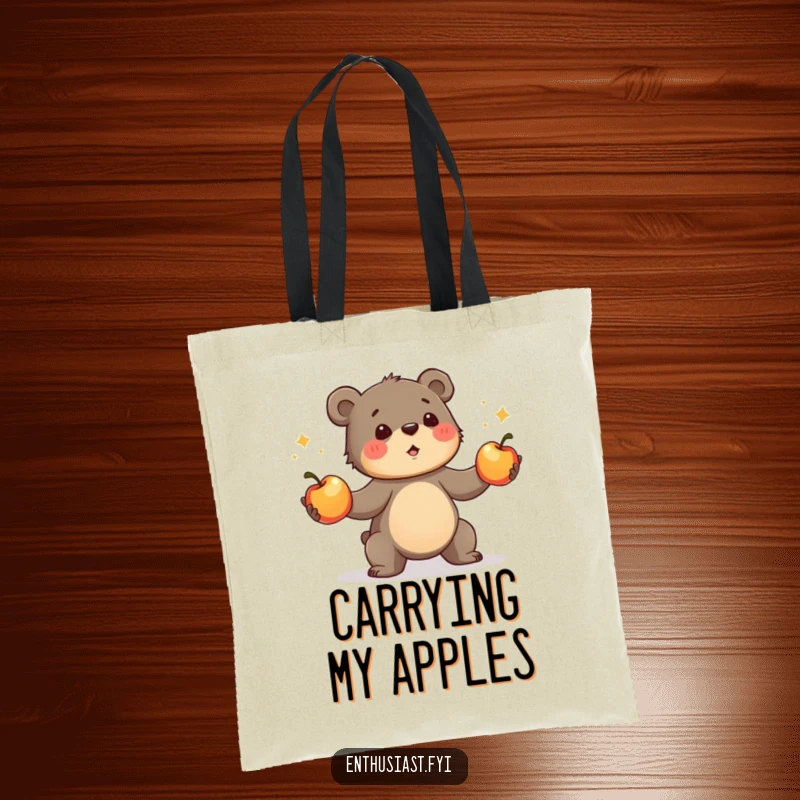 Funny bear cub tote bag, depicting a determined cub enthusiastically juggling three shiny apples. Great humorous and practical gift.