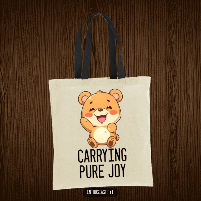 Funny bear tote bag showing a joyful bear character with a wide grin, holding up a luminous, imaginary glowing object.