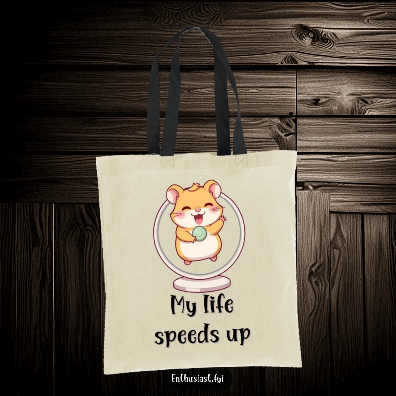 Funny tote bag with a giggling hamster excitedly running on a spinning wheel, perfect for carrying essentials with a smile.
