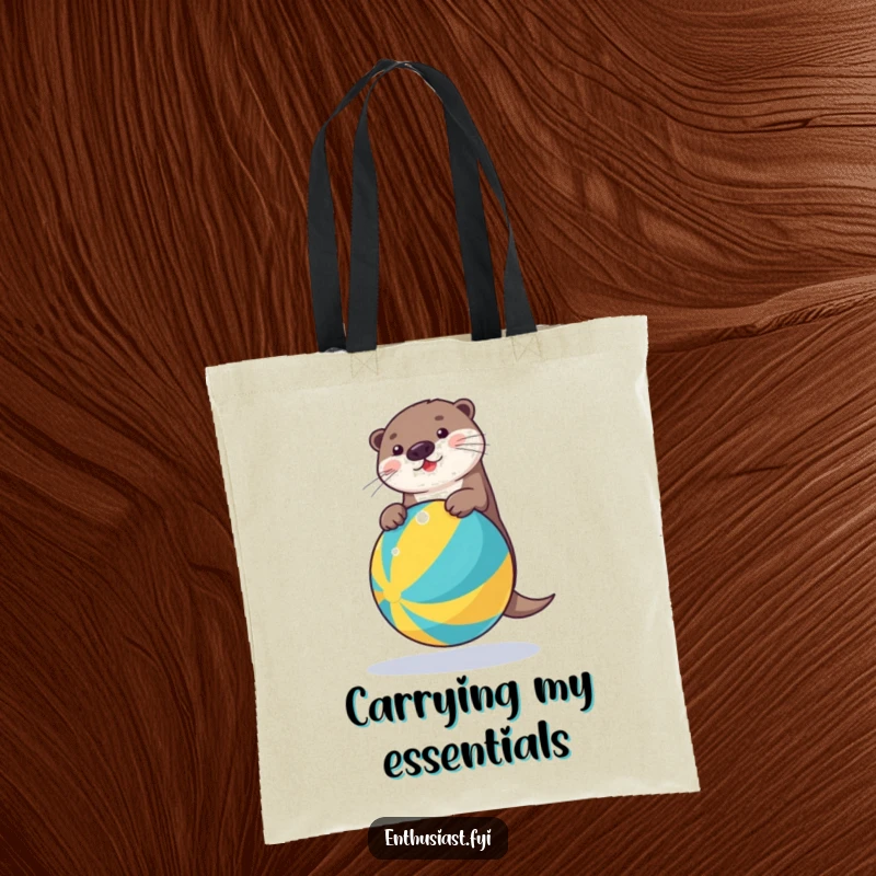 Funny tote bag featuring a plucky otter masterfully balancing on a bright beach ball, ideal for carrying essentials with a smile.