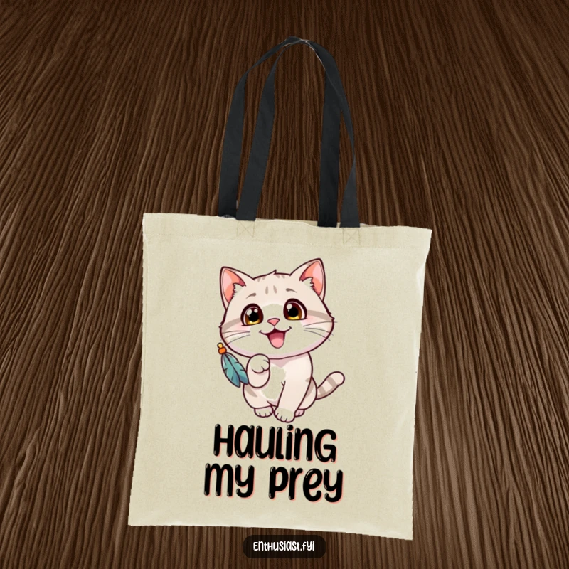 Funny cat tote bag with a cheerful cat's wide eyes, gleefully batting at a dangling feathered toy, a playful accessory.