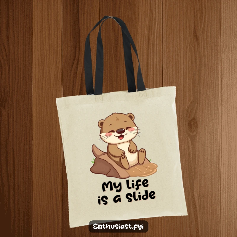 Funny tote bag with a playful otter joyfully sliding down a small, muddy incline, perfect for carrying groceries with a smile.